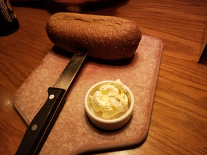 Bread and butter on wooden cutting board