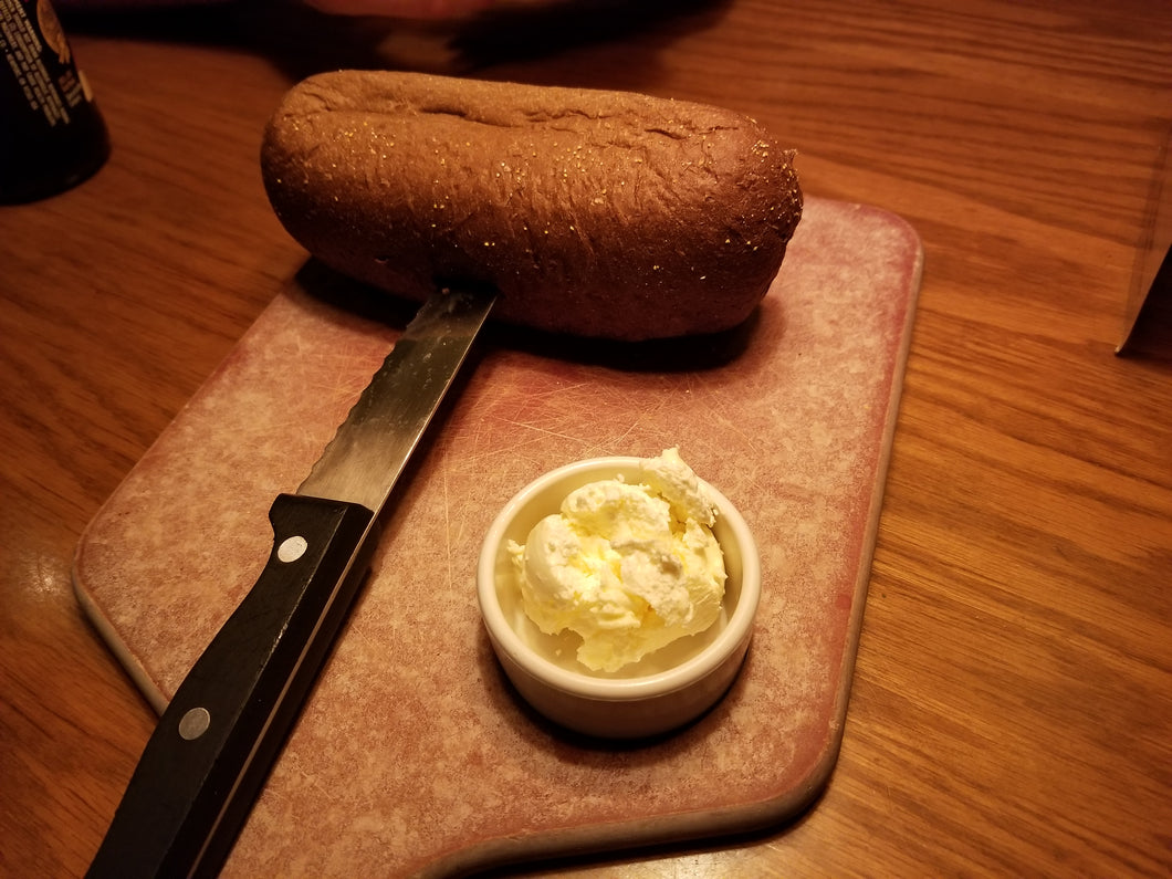 Bread and butter on wooden cutting board