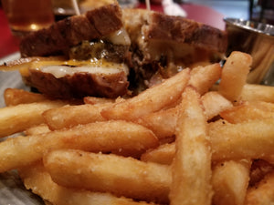 Close up of French fries and a sandwich