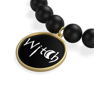 The word Witch in white creepy letters on a black  Matte Onyx Bracelet