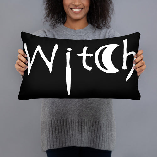 The word Witch in white creepy letters on a black pillow