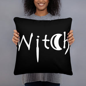 The word Witch in white creepy letters on a black pillow